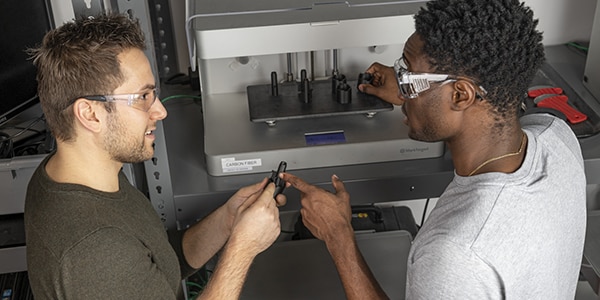 Two people on a site tour of the CNC machine shop at the Autodesk San Francisco Technology center