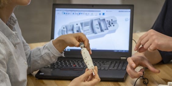 Instructor teaching students in CNC lab 