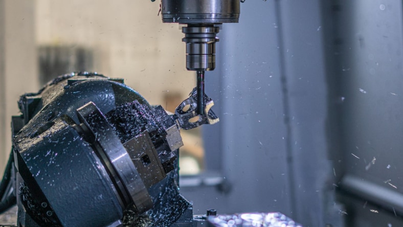 A mountain bike pedal being manufactured